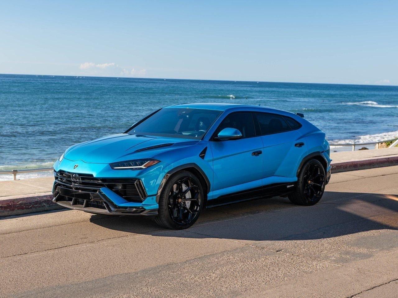 Lamborghini Urus bleue, trois quarts avant en bord de mer